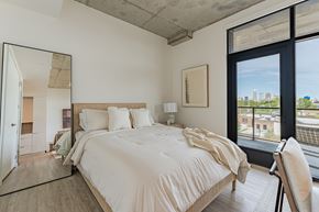 Cleveland apartment for rent - A bedroom with a large bed and a view of the city.