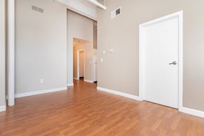 Cleveland apartment for rent - a living room and hallway with wood flooring and a white door
