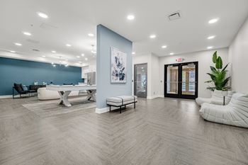 A spacious room with a blue accent wall and a white chair.