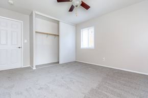 Willoughby apartment for rent - a bedroom with a ceiling fan and a closet