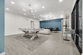 Cleveland townhouse for rent - A room with a pool table and chairs. at Park Lamont Townhomes Apartments, Ohio