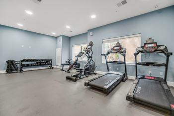 A spacious room with treadmills and other exercise equipment.