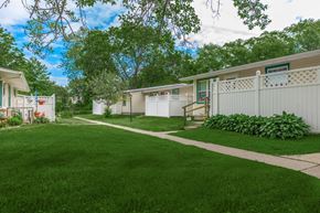 Painesville apartment for rent - a home with a green lawn and white fence