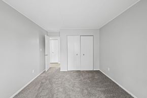 Eastlake apartment for rent - a bedroom with white walls and carpet and white closets
