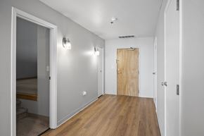 Cleveland apartment for rent - A hallway with a wooden floor and white walls.