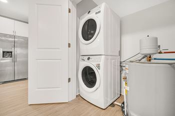 A white washing machine is in a small room.