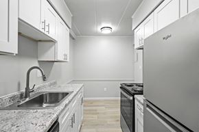 Eastlake apartment for rent - the kitchen in a new home with white cabinets and granite counter tops