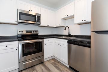 Sandusky apartment for rent - a kitchen with stainless steel appliances and white cabinets