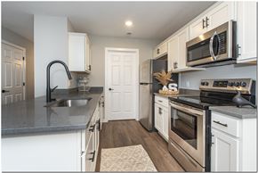 North Ridgeville apartment for rent - a kitchen with stainless steel appliances and white cabinets