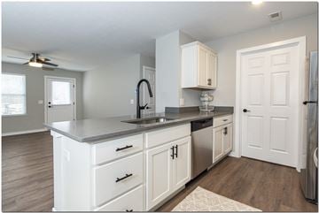 North Ridgeville apartment for rent - a kitchen with white cabinets and a sink and a refrigerator
