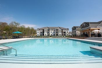 A swimming pool with apartments in the background
