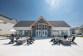 Lancaster apartment for rent - a patio with tables and chairs in front of a building at The Bend, Lancaster, OH, 43130