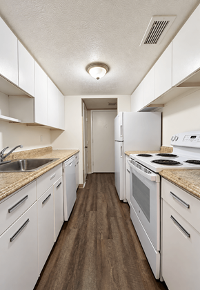 Parma Heights apartment for rent - A kitchen with white cabinets and appliances.