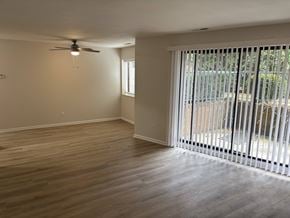 Huron apartment for rent - A room with a ceiling fan and sliding glass doors.