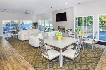 Westlake apartment for rent - a living room with a table and chairs and a television