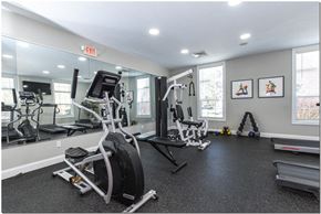 Madison apartment for rent - a gym with a lot of exercise equipment and mirrors on the wall
