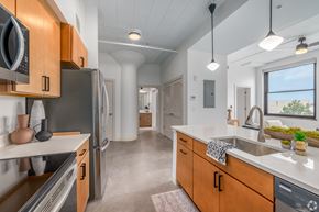 Cleveland apartment for rent - kitchen with wooden cabinets at Life At Agora, Ohio, 44103