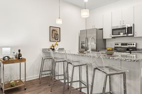 Cleveland apartment for rent - A kitchen with a white counter top and stainless steel appliances. at The Lumos Apartments, Ohio, 44106