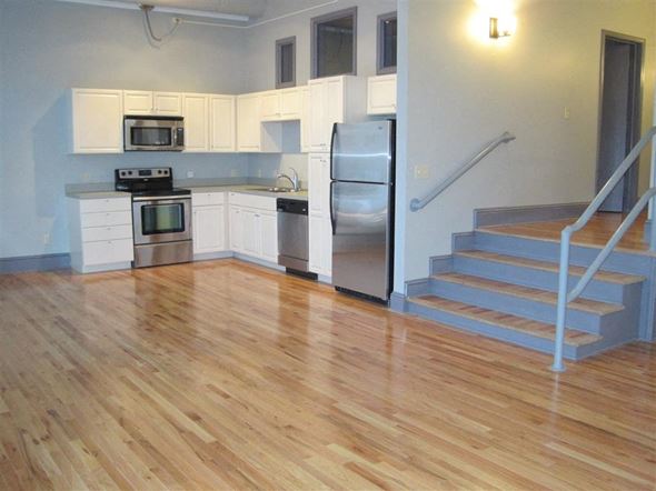 Cleveland apartment for rent - an empty kitchen with a wooden floor and stainless steel appliances