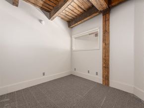 Cleveland apartment for rent - a bedroom with white walls and a ceiling with wooden beams