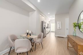 Cleveland townhouse for rent - A modern dining room with a glass table and chairs. at Park Lamont Townhomes Apartments, Ohio