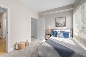 Cleveland townhouse for rent - A bedroom with a large bed and a picture on the wall. at Park Lamont Townhomes Apartments, Cleveland, OH, 44106
