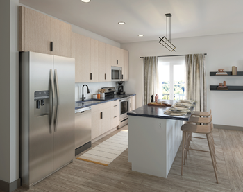 A modern kitchen with a large island and a refrigerator.