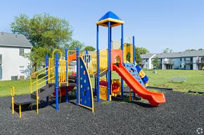 Columbus apartment for rent - A playground with a blue and yellow structure and a red slide.