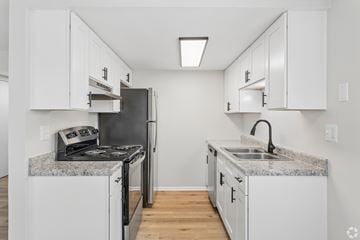 Columbus apartment for rent - A kitchen with white cabinets and granite countertops.