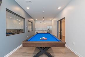 Cleveland apartment for rent - A pool table in a room with a window and a door. at The Lumos Apartments, Cleveland, Ohio