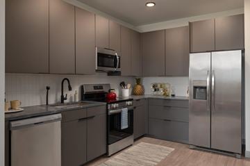 Cleveland apartment for rent - A modern kitchen with a stainless steel refrigerator and a microwave above the stove.