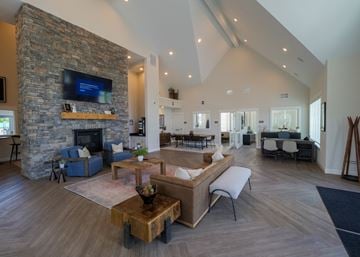 Lancaster apartment for rent - a large living room with a stone fireplace and a television