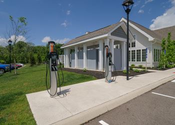 A gas station with two pumps in front of a house