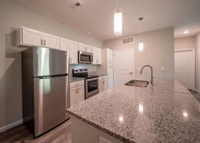Lancaster apartment for rent - a kitchen with a granite counter top and stainless steel refrigerator at The Bend, Lancaster, OH, 43130