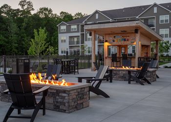 An outdoor entertaining area with a fire pit and patio furniture