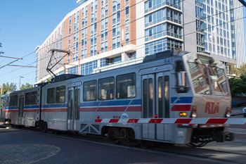 A train with the letters rta on the front is on a track.
