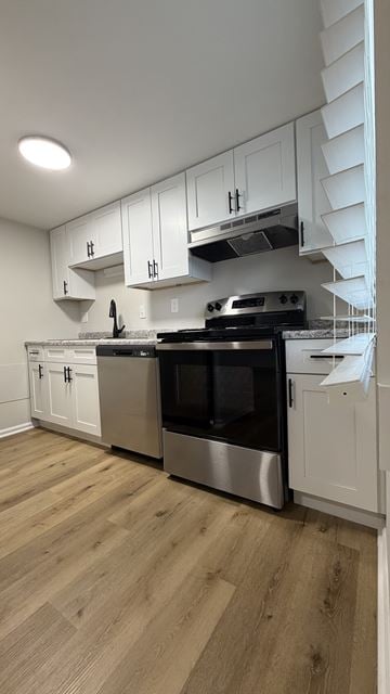 Columbus apartment for rent - A kitchen with stainless steel appliances and white cabinets.