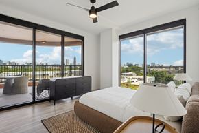 Atlanta apartment for rent - A bedroom with a large bed and a view of the city.