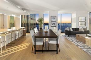 Seattle apartment for rent - a kitchen and dining area with a wooden table and white chairs