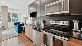 Denver apartment for rent - A modern kitchen with a stainless steel oven and microwave.