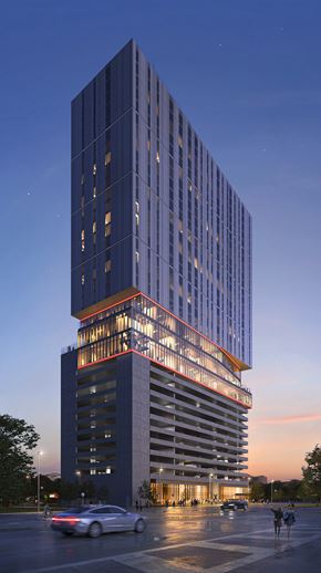 Houston apartment for rent - A tall building with a red outline at the base is lit up at dusk.