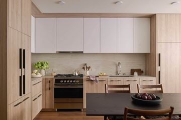 San Francisco apartment for rent - A modern kitchen with wooden cabinets and a black table.