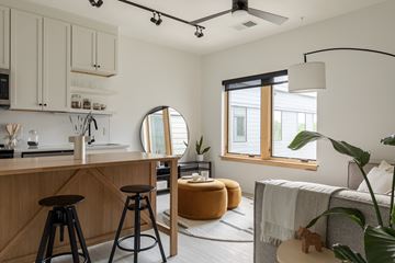 Charlotte apartment for rent - A modern kitchen with wooden cabinets and a bar area.