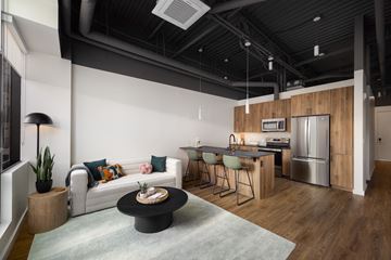 Phoenix apartment for rent - a living room with a couch and a table in front of a kitchen