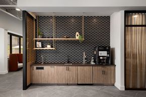 Phoenix apartment for rent - a kitchen with wooden cabinets and a black and white tile wall