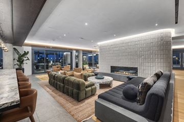 San Francisco apartment for rent - A modern living room with a large sectional sofa and a fireplace.
