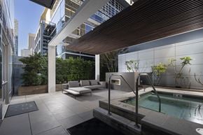 San Francisco apartment for rent - A hot tub is surrounded by a cushioned seating area on a rooftop patio.