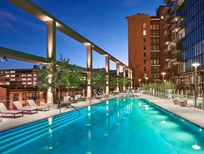 Los Angeles apartment for rent - Rooftop pool and sundeck at dusk at Sentral DTLA.