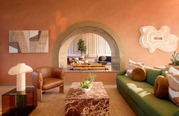 Phoenix apartment for rent - A living room with a green couch and a brown chair.