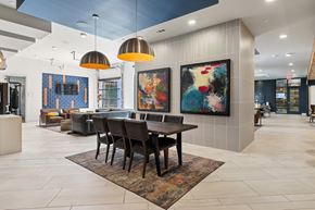 Austin apartment for rent - A modern dining room with a large painting on the wall.